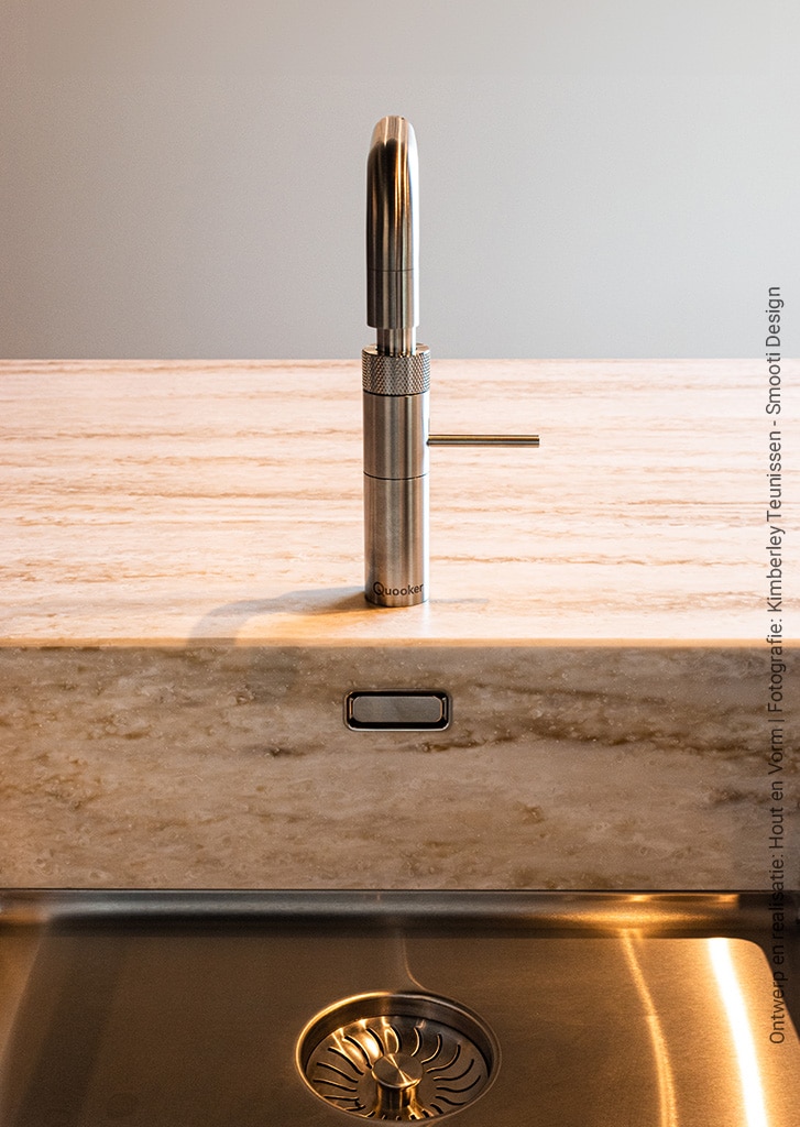 Detailfoto van een werkblad in een keuken gemaakt van solid surface decor Weathered Wood van Durasein in combinatie met een RVS kraan en spoelbak.