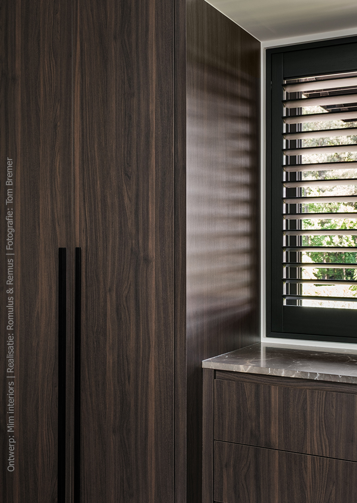 Maatwerkkasten in LN55 Maloja houtdecor met subtiele structuur en warmbruine tint, geïnspireerd op mat gelakt notenhout.